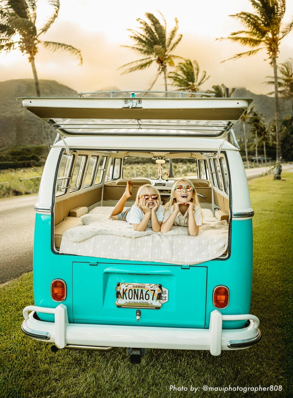 Children relaxing in the back of a vintage VW bus during a Maui lifestyle family photoshoot